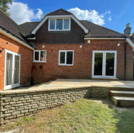 View of wall from lawn Indian Sandstone Patio. The New Driveway Company