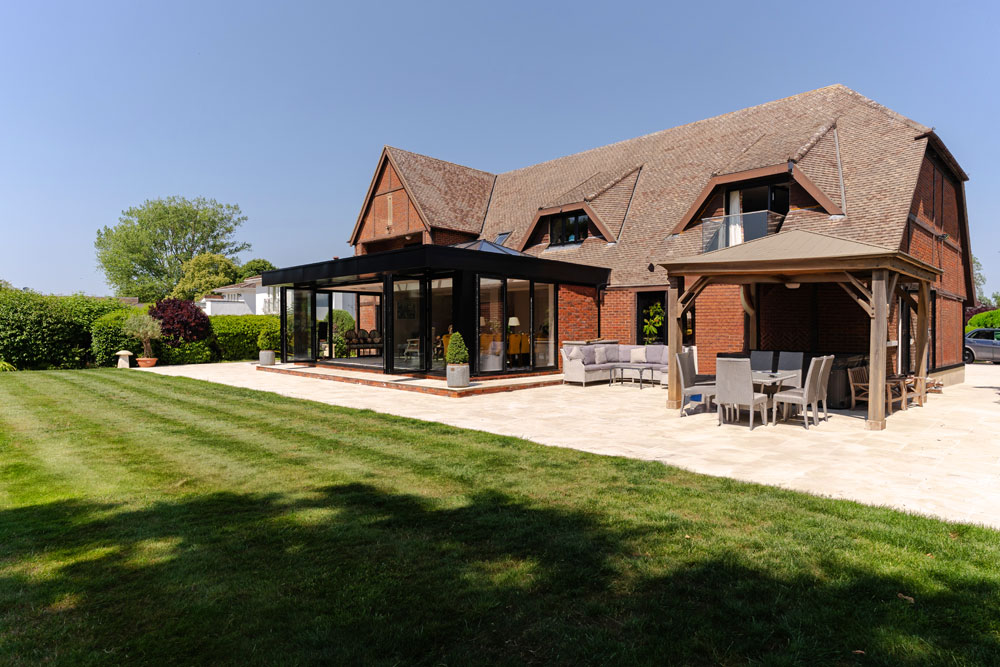 View of the patio from the lawn Porcelain Patio, Watlington. New Driveway Company