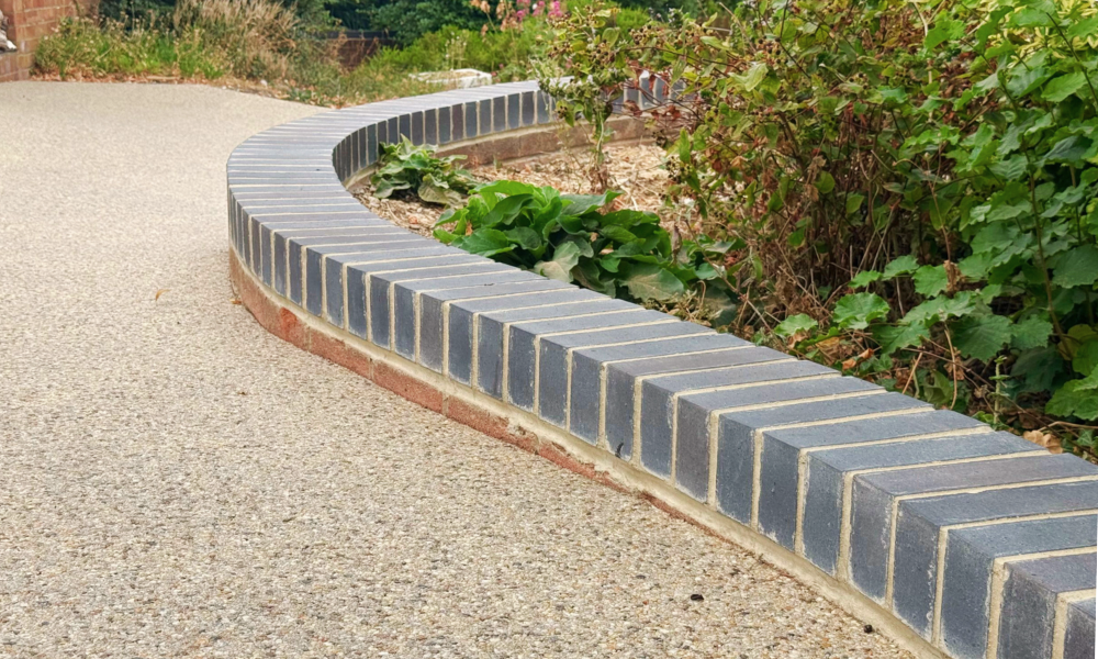 Resign driveway with blue engineering block wall