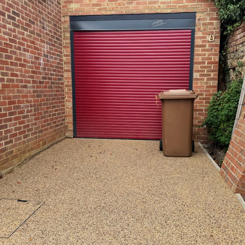 Red garage door and new resin driveway