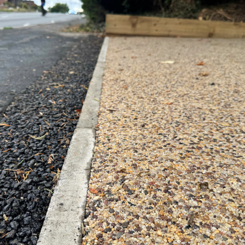 Concrete edging between tarmacpath and resin driveway